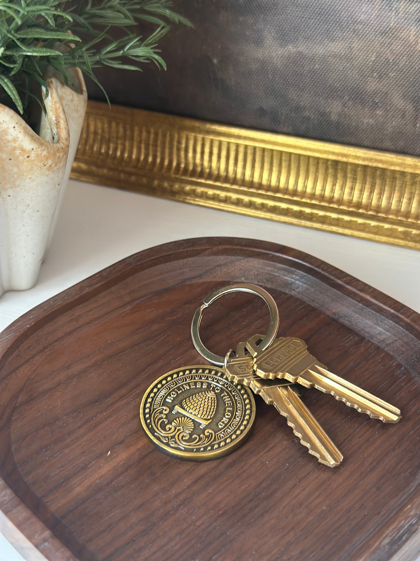 antiqued brass LDS keychain with temple inspired engraving .