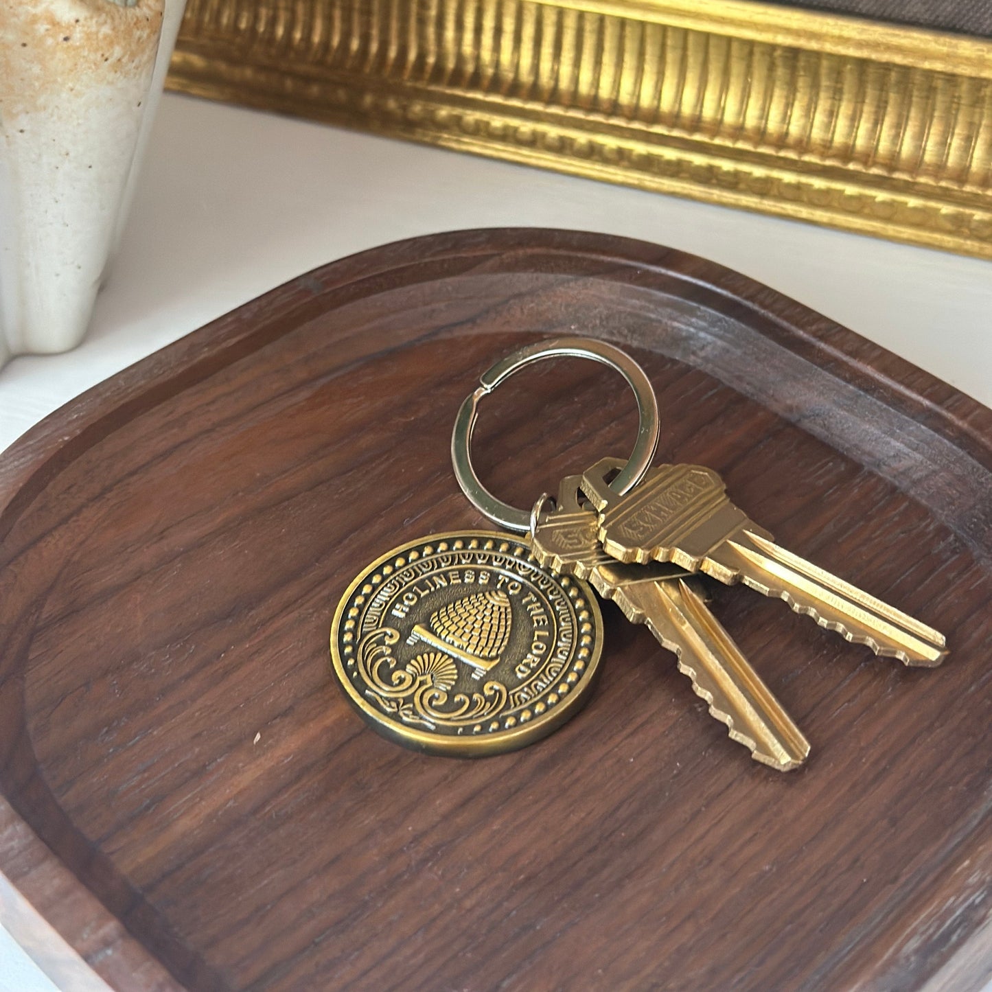 antiqued brass LDS keychain with temple inspired engraving .