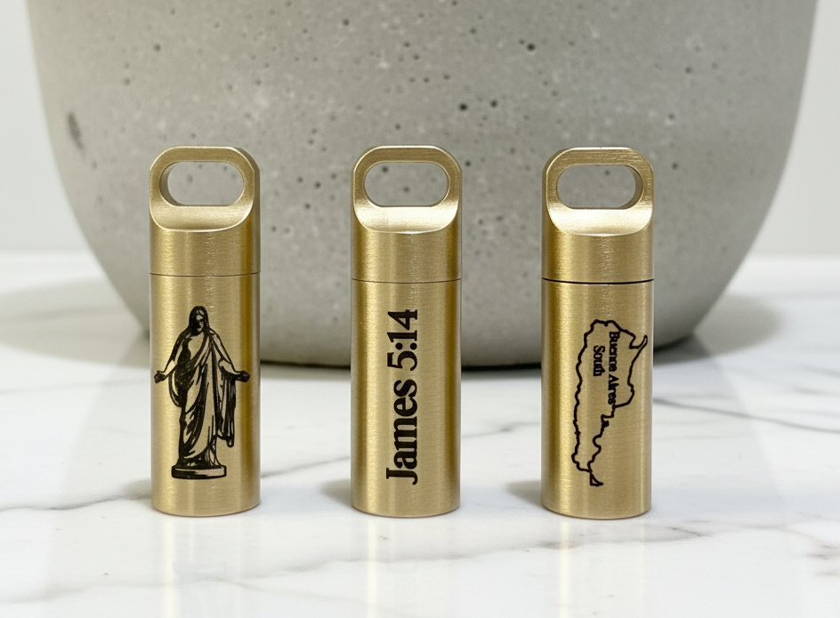 Three brass containers with engraved designs on a marble surface. LDS oil vial 