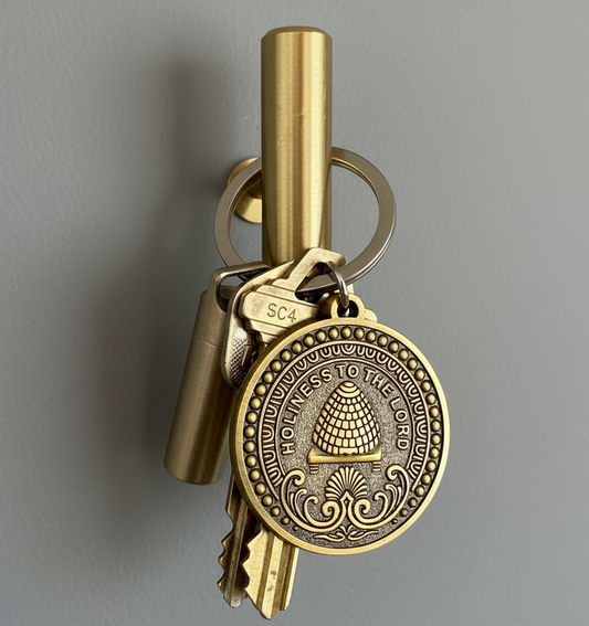 LDS keychain with a key and decorative pendant on a gray background