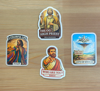 Four stickers featuring religious figures and a cityscape on a wooden surface